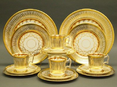 Royal Chelsea "Cathedral" Service: A Royal Chelsea Porcelain "Cathedral" Pattern Dinner Service, 60 Pieces. White porcelain with ornate gilt decoration with orange-red accents of color. Includes 12 salad plates, 12 bread and butter pla