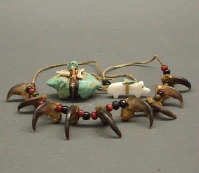 2 Zuni fetishes & a bear claw necklace: Two Zuni Fetishes and a Bear claw Necklace. Group comprises two carved stone animal form fetishes and a beaded and Bear claw necklace strung together on a hide string. Wear to each. From 1 3/4" to 14"