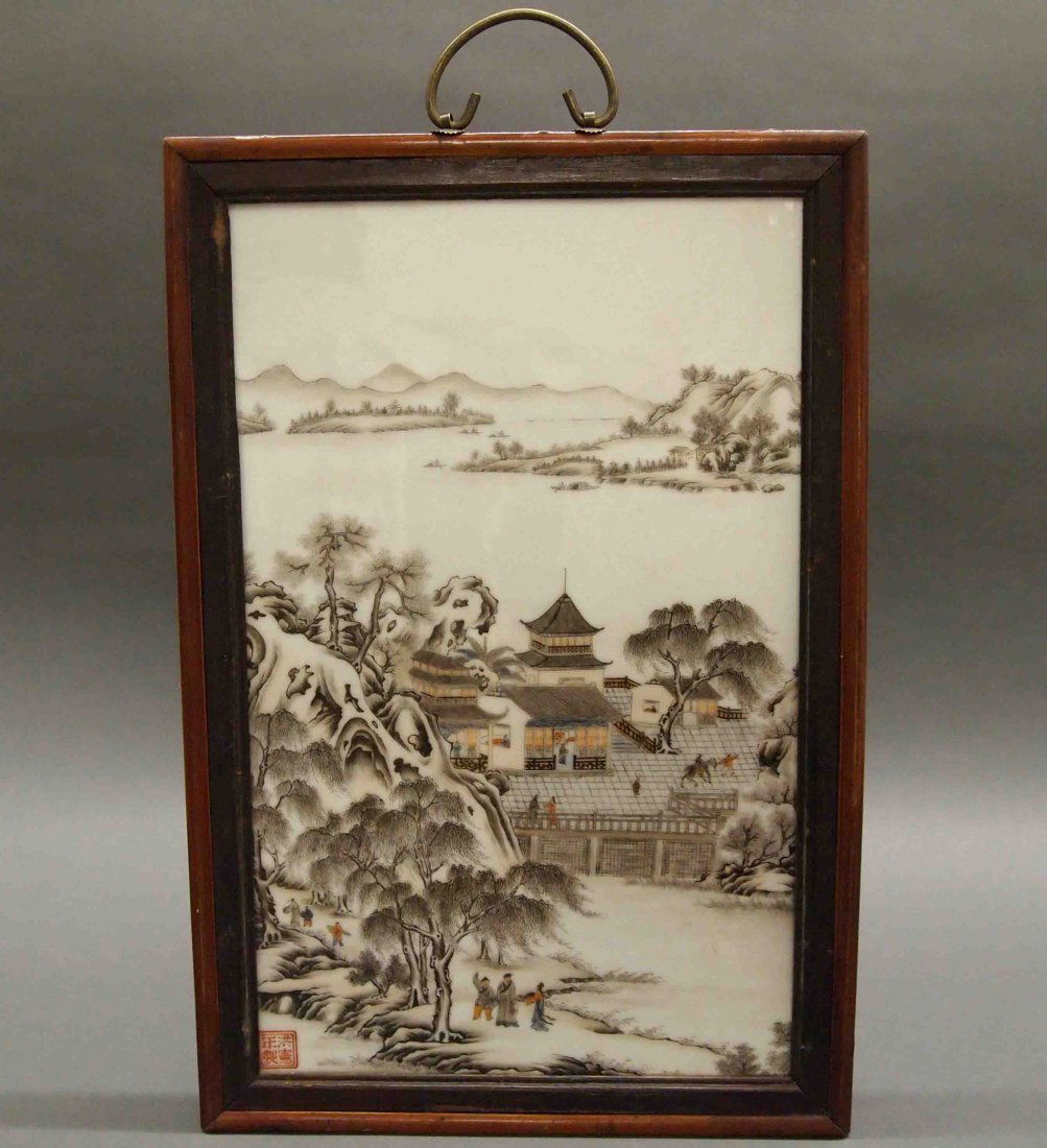 Chinese Porcelain Plaque: A Chinese Painted Porcelain Plaque. Hand painted motif consists of a coastal village with figures bustling about within the buildings and about the landscape, in various pursuits. Red four character m