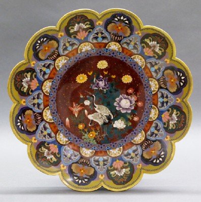 Japanese Cloisonné Charger: A Japanese Cloisonné Charger. Having a Scalloped rim, stylized floral vignettes, and geometric borders that surround the Mica flecked well, which is filled with a multi-color floral and crane motif.