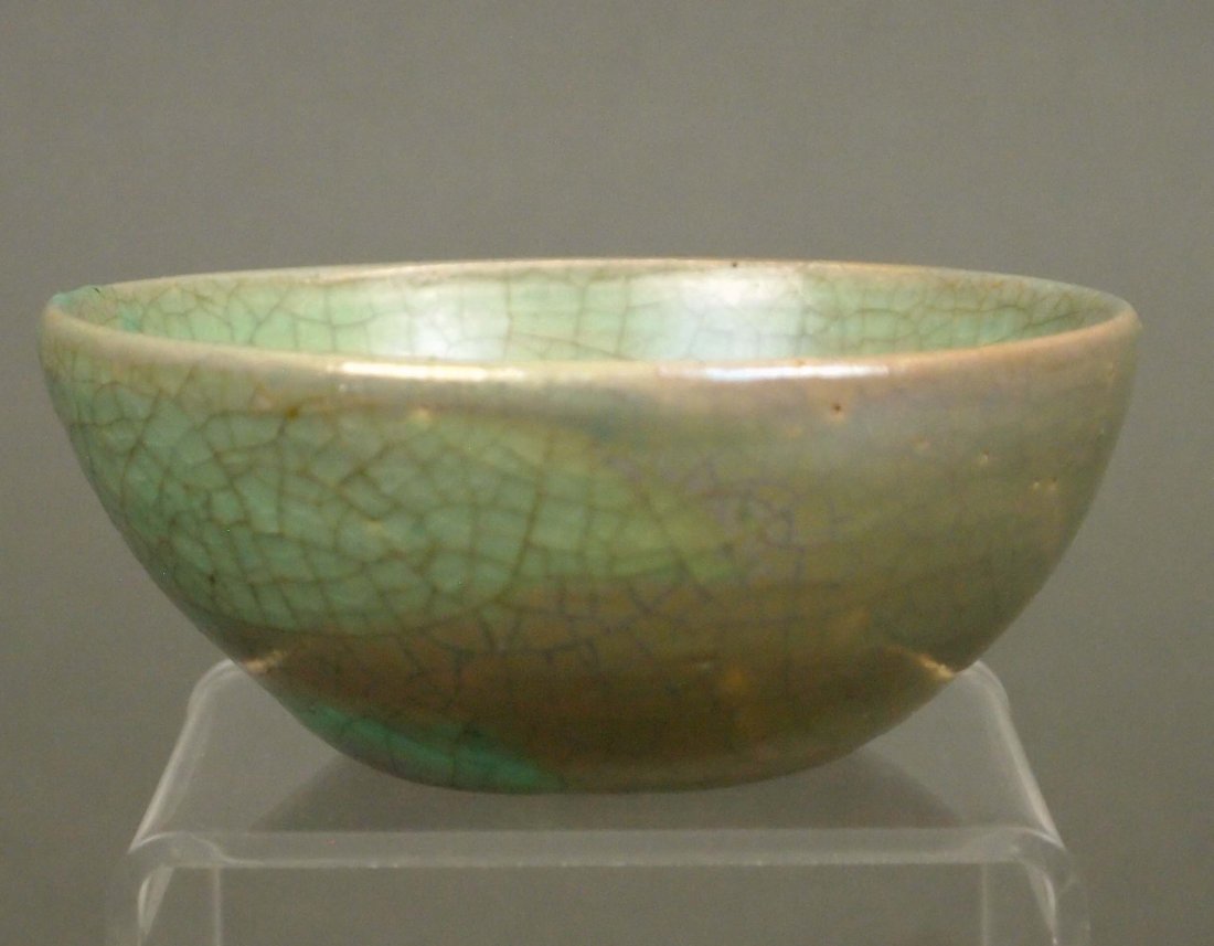Pewabic Pottery Bowl: An Early 20th Century Pewabic Pottery Bowl. Diminutive bowl with green matte glaze at the interior and iridescent lustre glaze at the exterior. Impressed Pewabic mark and paper label at the underside.