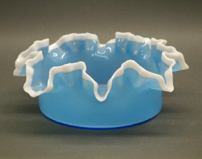 Victorian Glass Bowl: A Victorian Cased Glass Bowl. Blue glass Bowl with White ruffled rim. Polished pontil; unmarked. Very minor wear. 4 1/2" x 10 1/2" diameter. ESTIMATE $100-200
