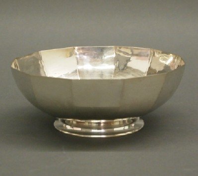 Old Newbury Crafters Bowl: An Old Newbury Crafters Sterling Bowl, designed by Chester A. Dow. Simple hand wrought bowl with paneled sides rests on a small foot. Stamped with trademark logo along with "Sterling", "Hand wrought",