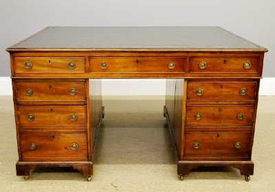 Mahogany Partner's desk: A 19th century English Mahogany Partner's desk. Molded top with Green inset leather writing surface and Gold tooled edge detail, having three dovetailed drawers at either side with three drawers in ea