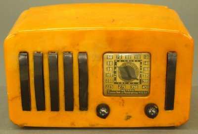 Emerson Catalin Radio: A 1941 "Emerson Radio and Phonograph Corp. Model EP375 "5+1" Catalin" tabletop radio, butterscotch body with maroon trim. Minor wear with some scratching to the top and hairline crack in body. 9 1/2" 