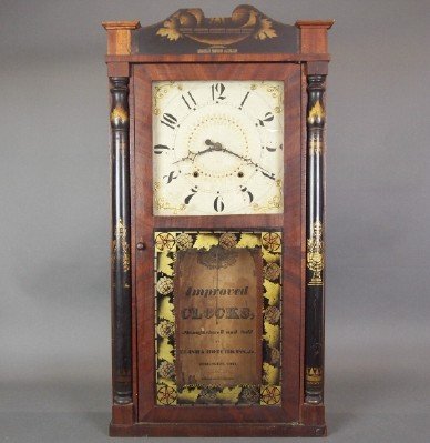 Elisha Hotchkiss Jr. shelf clock: A 19th century Elisha Hotchkiss Jr. shelf clock. 30 hr time and strike weight driven wooden movement with painted wooden dial. Mahogany case with shaped stenciled crown above a single door with clear 