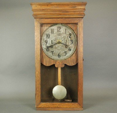International Time Recording clock: An early 20th International Time Recording wall clock. 8 day time only driven with double Up/Down wind indicators on dial. Oak case with single door. Older refinishing in fair condition, reduced in he