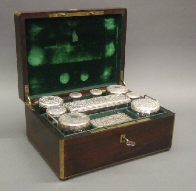 French Silver Necessaire: A 19th Century French Silver Necessaire by Joseph Chaumet, French, 1852-1928. Consisting of a rosewood box with brass fittings and inlay which opens to reveal fitted compartments clad in emerald green