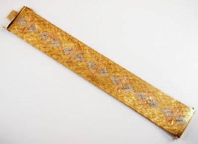 18k Gold bracelet: A 20th century 18k Yellow Gold bracelet with inlaid White and Rose gold decoration and engraved detail. Minor wear. 8" long. 102.5 grams total weight. ESTIMATE $3,000-4,000 ex. collection Princess Zor