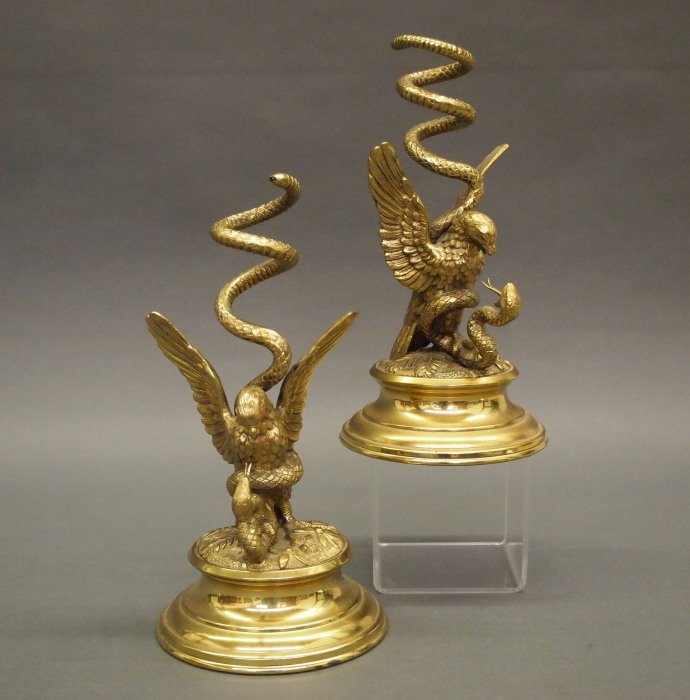 Pr. Of Brass Epergnes: A Pair of Late 19th Century Brass Epergne Bases. Each coil acts as a support for the glass vase inserts, which is situated above the elaborate base that consists of an Eagle battling a Snake. Includes