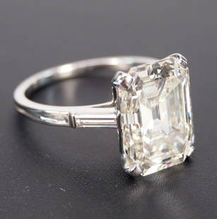 6.72ct Emerald Cut diamond ring: A Ladies major emerald cut diamond ring. Platinum mount centered by an emerald cut diamond weighing 6.72 carats, and two straight baguette cut diamonds totaling .20 carats. Total diamond weight 6.92 c