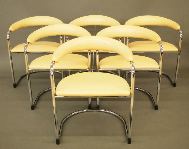 6 Anton Lorenz Mid Mod chairs: A set of six armchairs Designed by Anton Lorenz for Thonet. Each has a beige vinyl upholstered back and seat with tubular chrome cantilevered frame. Labeled underneath. Anton Lorenz, Hungarian, 1891-1