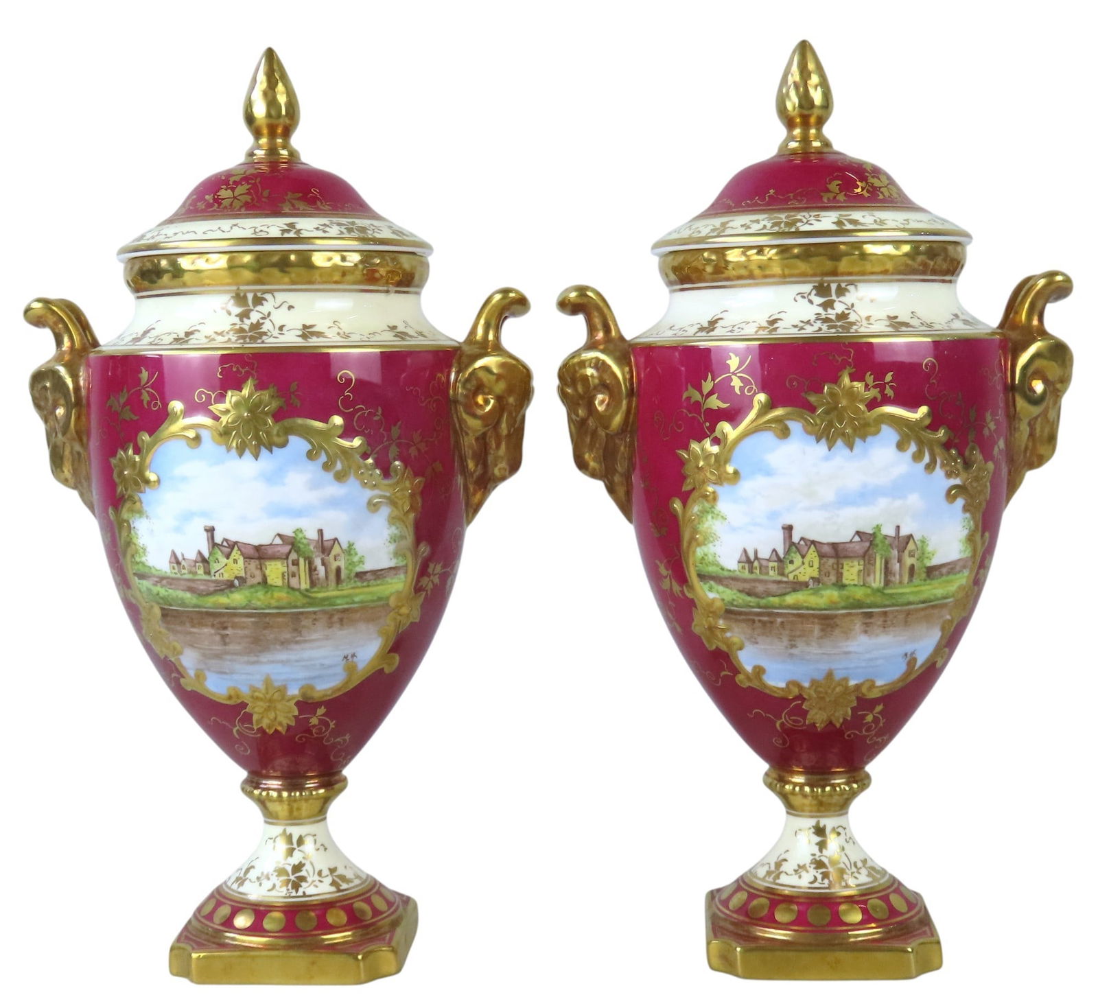 A PAIR OF COALPORT LIMITED EDITION MADELEY COURT VASES WITH COVERS CIRCA 1973 the urn form vases: A PAIR OF COALPORT LIMITED EDITION MADELEY COURT VASES WITH COVERS CIRCA 1973 the urn form vases flanked by twin goat mask handles, the sides painted with a view of Madeley Court within a central cart