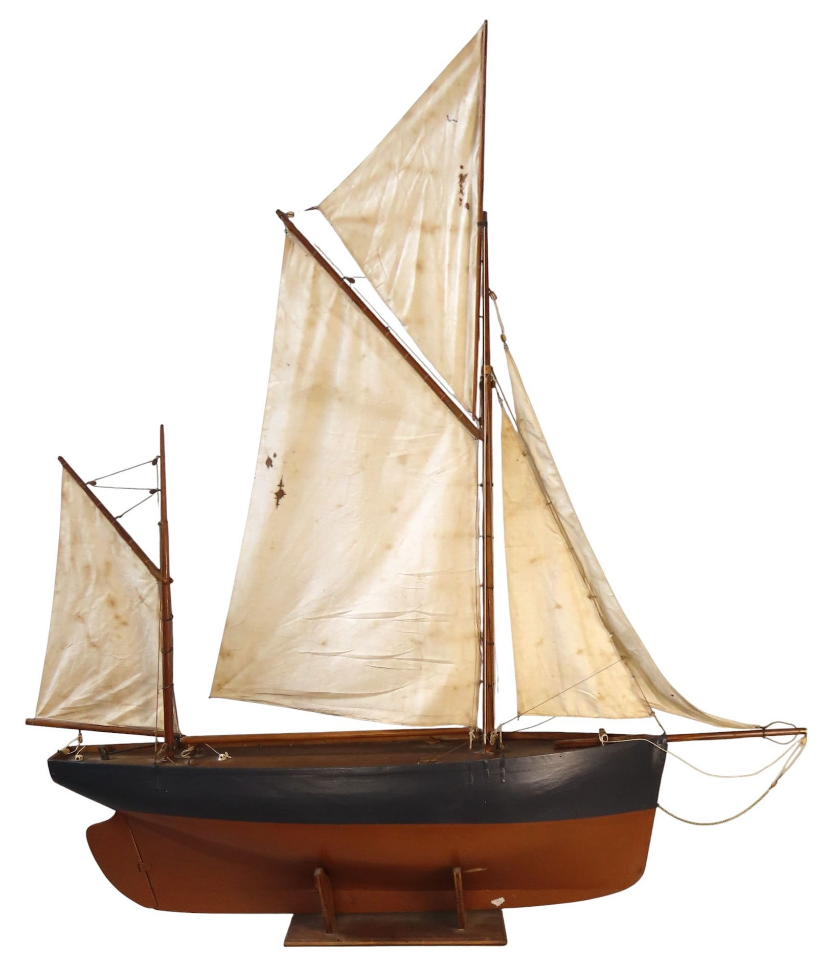 A GAFF RIGGED FULL HULL MODEL/POND YACHT LATE 19TH CENTURY with canvas sails and painted hull,: A GAFF RIGGED FULL HULL MODEL/POND YACHT LATE 19TH CENTURY with canvas sails and painted hull, mounted on a wooden stand
