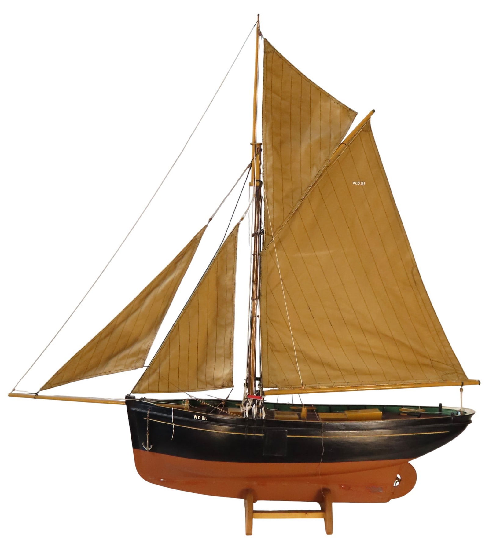 A FINE FULL HULL MODEL/POND YACHT LATE 19TH CENTURY of a 'smack' cargo vessel fully rigged with: A FINE FULL HULL MODEL/POND YACHT LATE 19TH CENTURY of a 'smack' cargo vessel fully rigged with canvas sails the hull painted black and brown and inscribed 'WD81' 128 cm high x 123 cm long x 23 cm wid