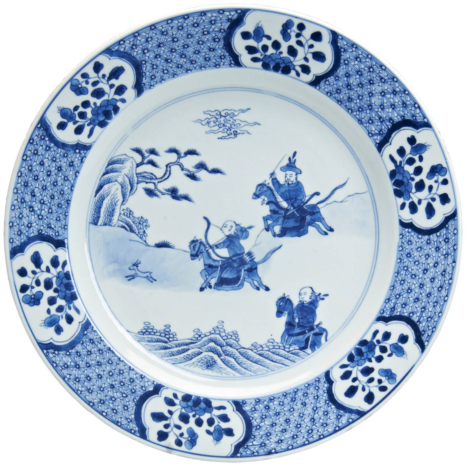 A LARGE BLUE AND WHITE DISH KANGXI PERIOD (1662-1722) painted in tones of underglaze blue with