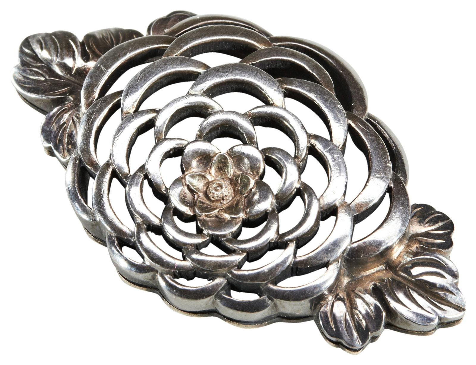 A JAPANESE SILVER-METAL OBIDOME 19TH CENTURY finely worked in the form of a chrysanthemum: A JAPANESE SILVER-METAL OBIDOME 19TH CENTURY finely worked in the form of a chrysanthemum blossom 5.0cm wide PROVENANCE: From the Eva & Aubrey Sweet Collection, Melbourne, Australia IMPORTANT INFORMAT
